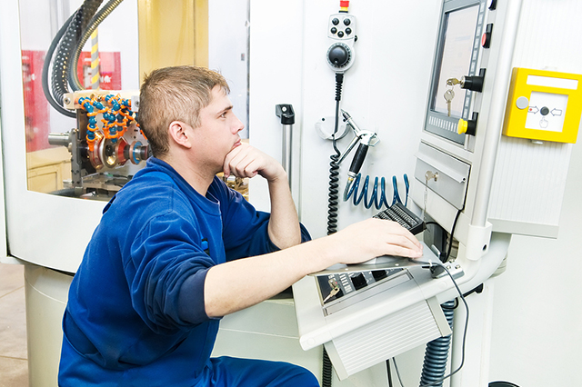 Worker at CNC nachine